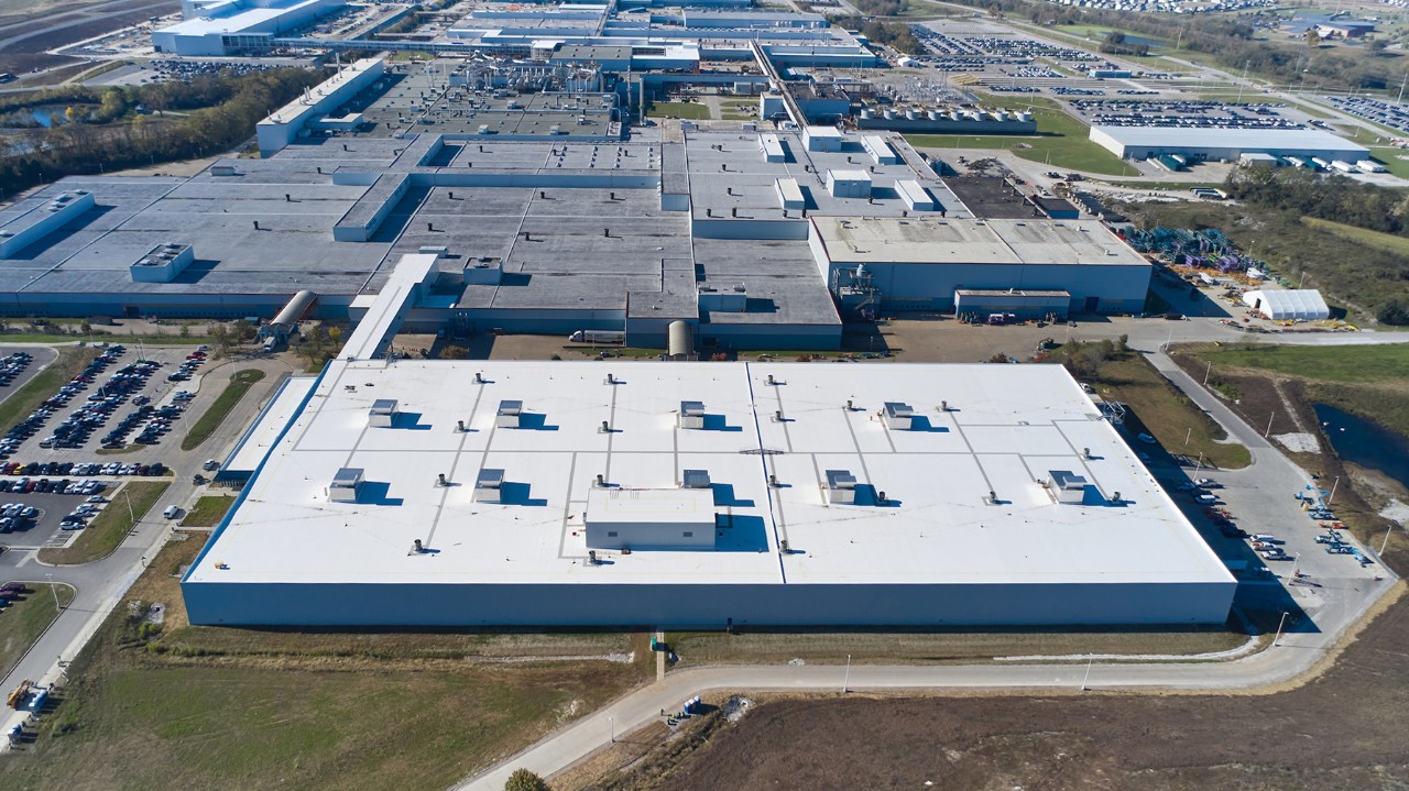 Spring-Hill Aerial view of a GM automotive manufacturing plant with expansive factory buildings and adjacent parking lots.