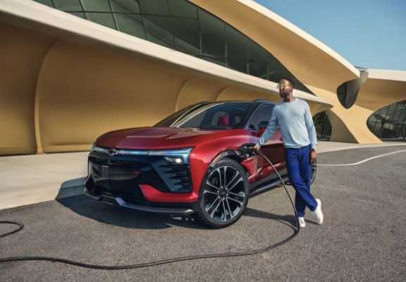 Man Plugging In His Blazer EV At Public Charging Station