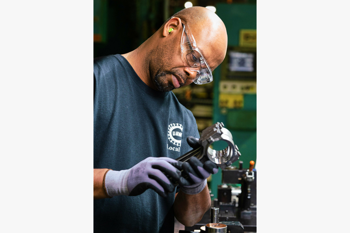 A General Motors Bay City Propulsion System employee inspects Gen 5 connecting rods for V-8 engines.