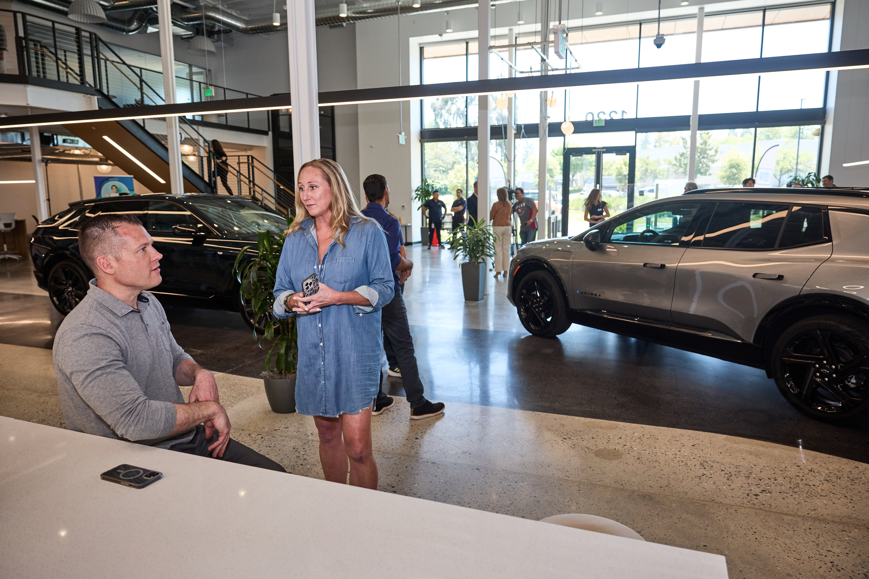 Team members talking at General Motors’ Mountain View Tech Center opening event.