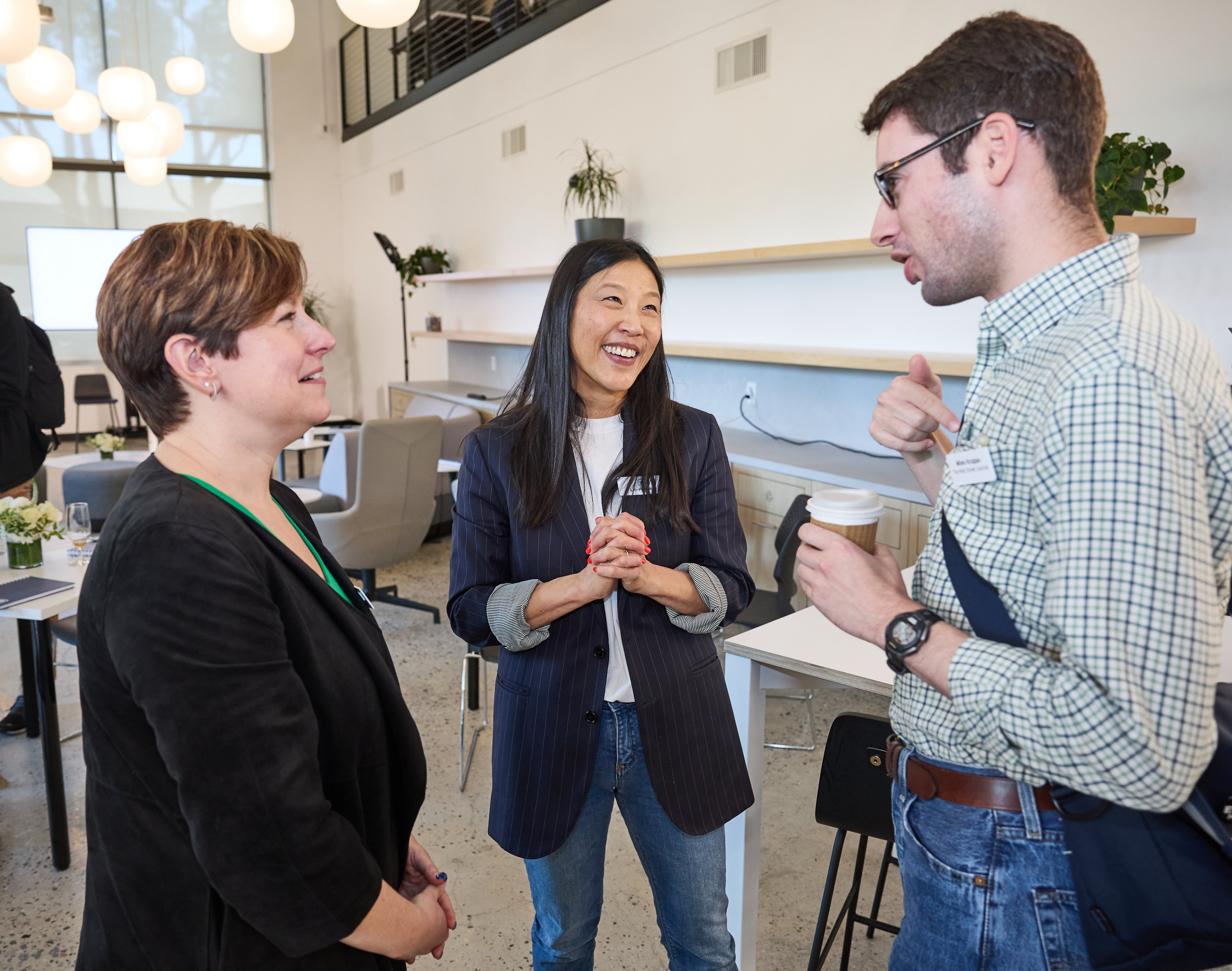 Team members talking at General Motors’ Mountain View Tech Center opening event.
