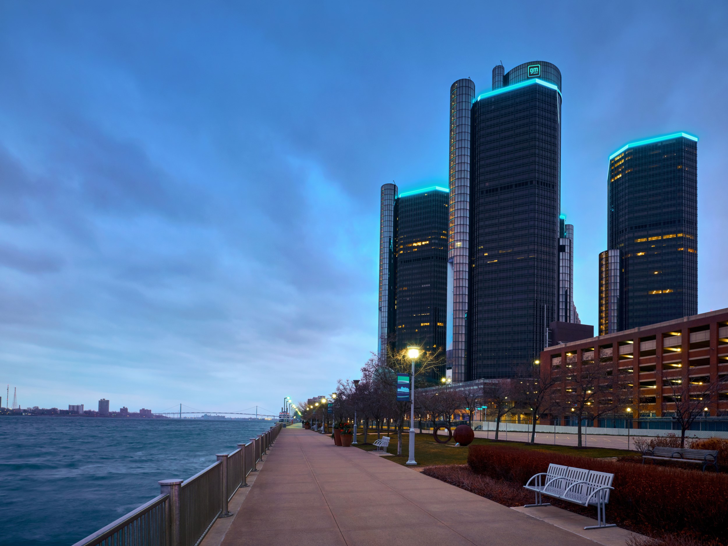 Text: view up of three Renaissance Center towers from Riverwalk along Detroit River 