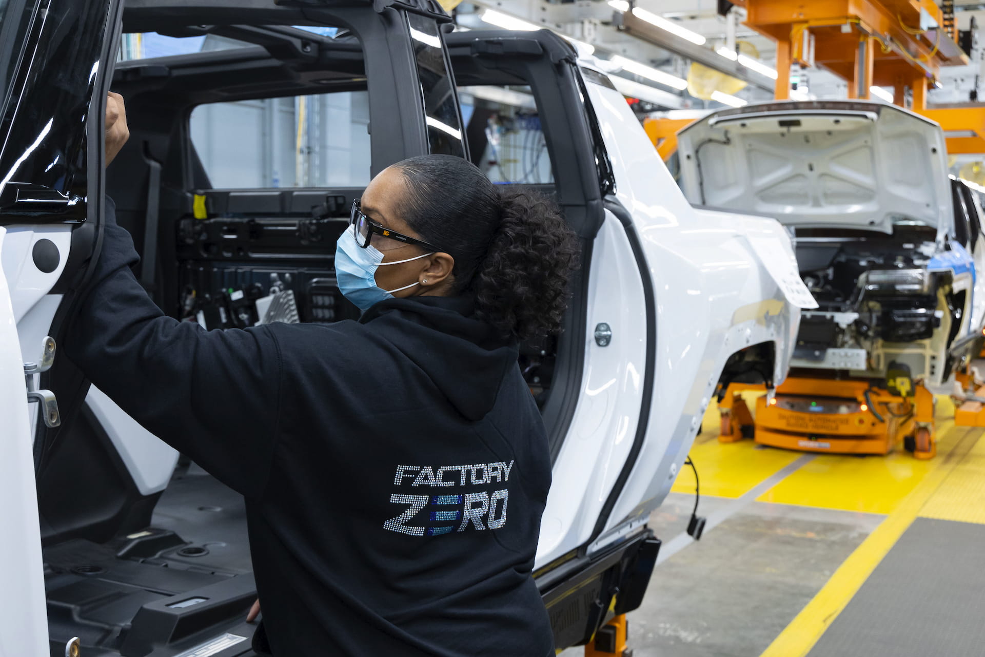 Assembly line worker works on Hummer EV interior