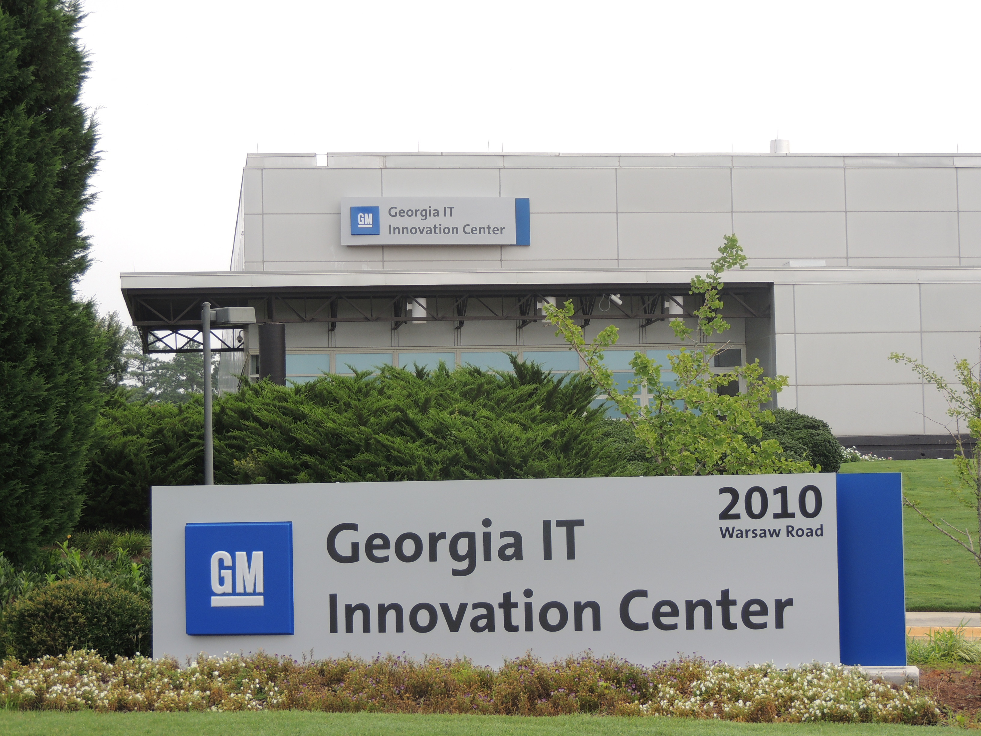 GM Georgia IT Innovation Center sign sits in front of beige building also with sign