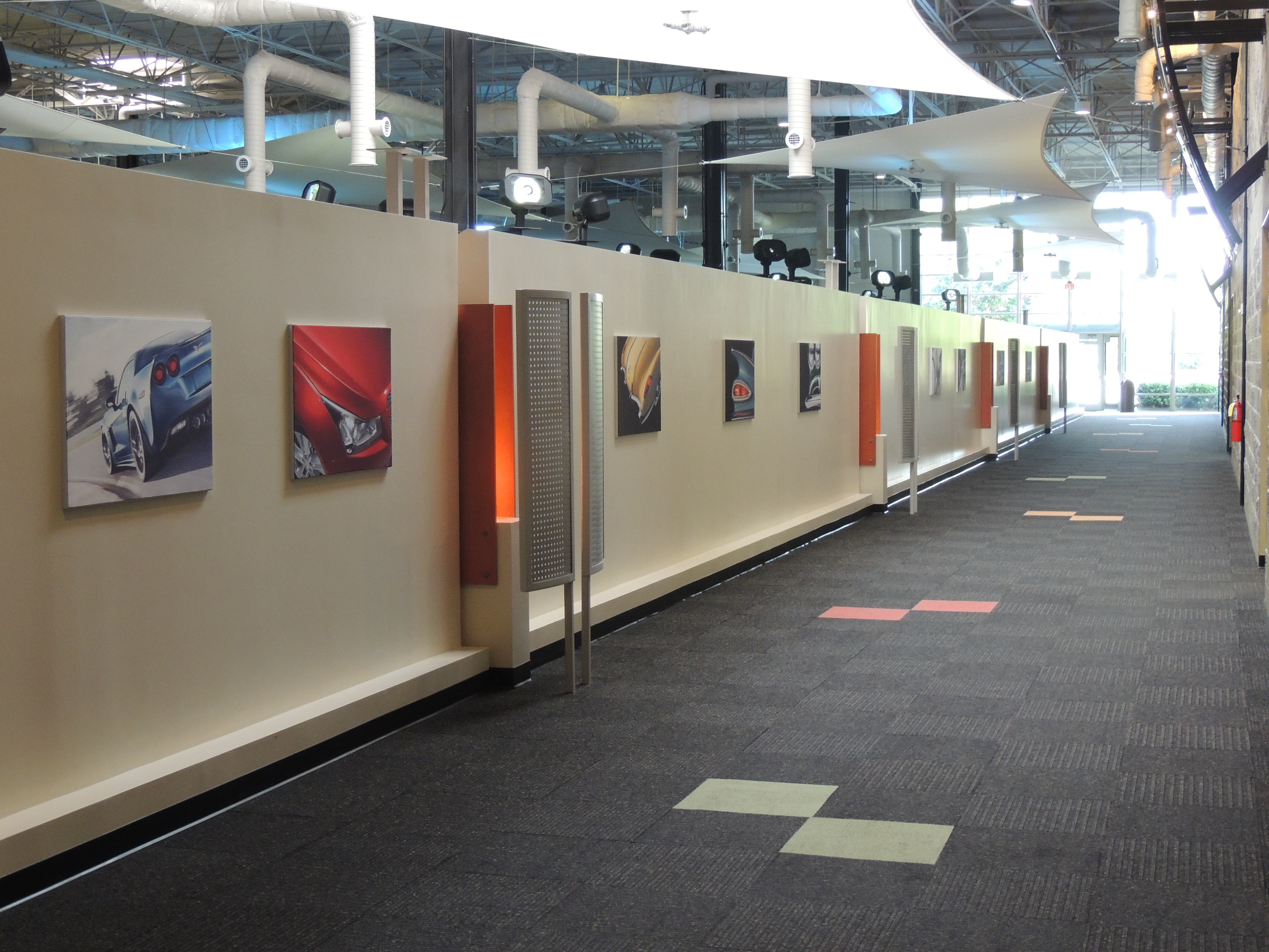 view down hallway with art on half walls and open ceiling at GM Georgia IT Innovation Center