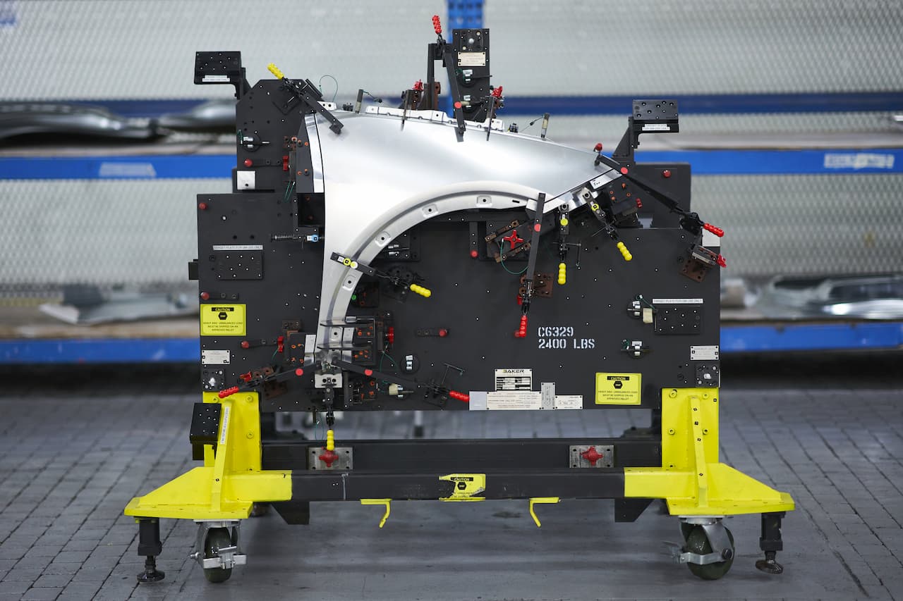 machined vehicle fender template sits on wheeled base