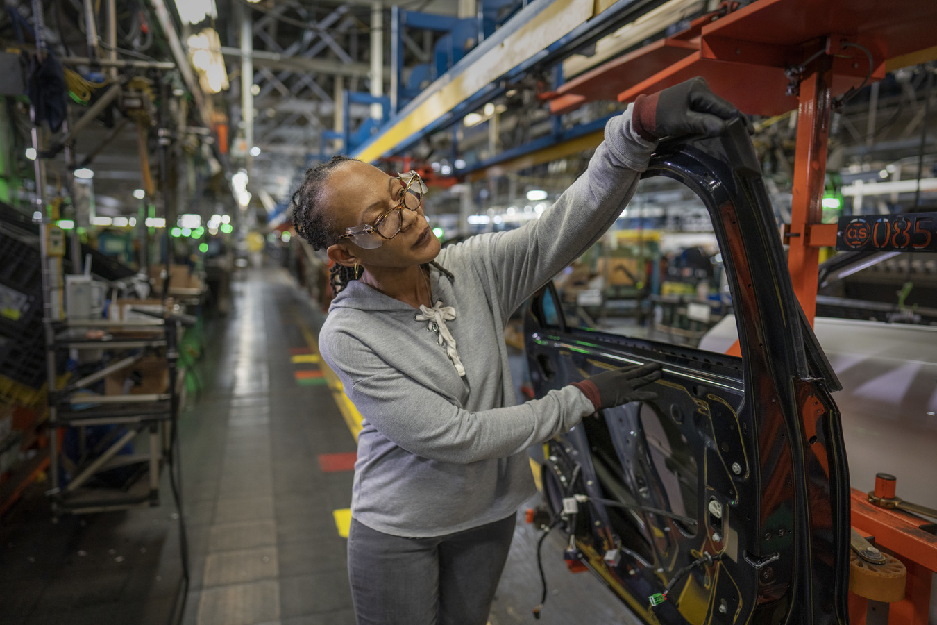 General Motors employee working on car door at Fairfax Assembly