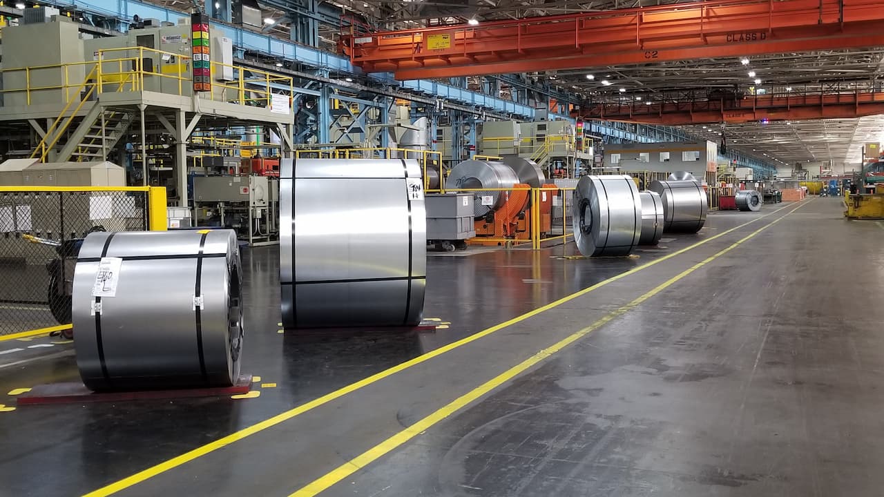 large metal rolls of various sizes are lined up on shop floor ready for production