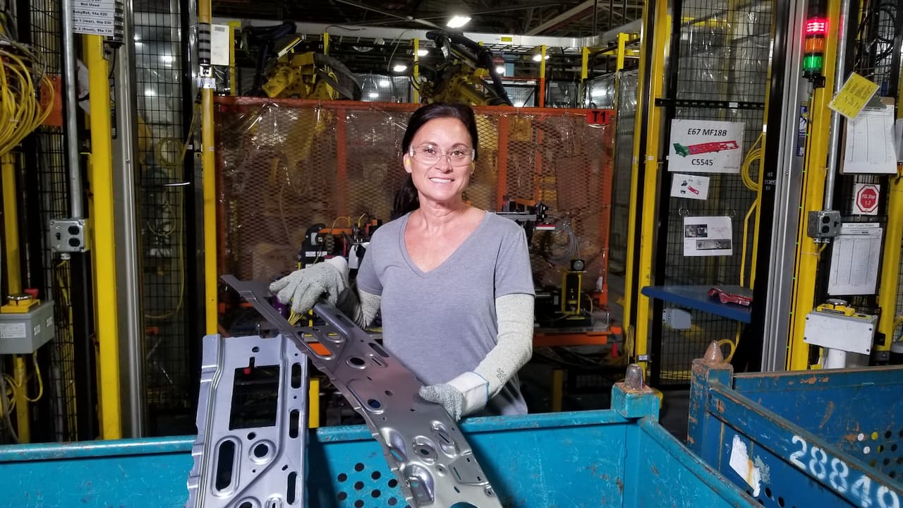 Gloris Dures lifts stamped sheet metal into bin
