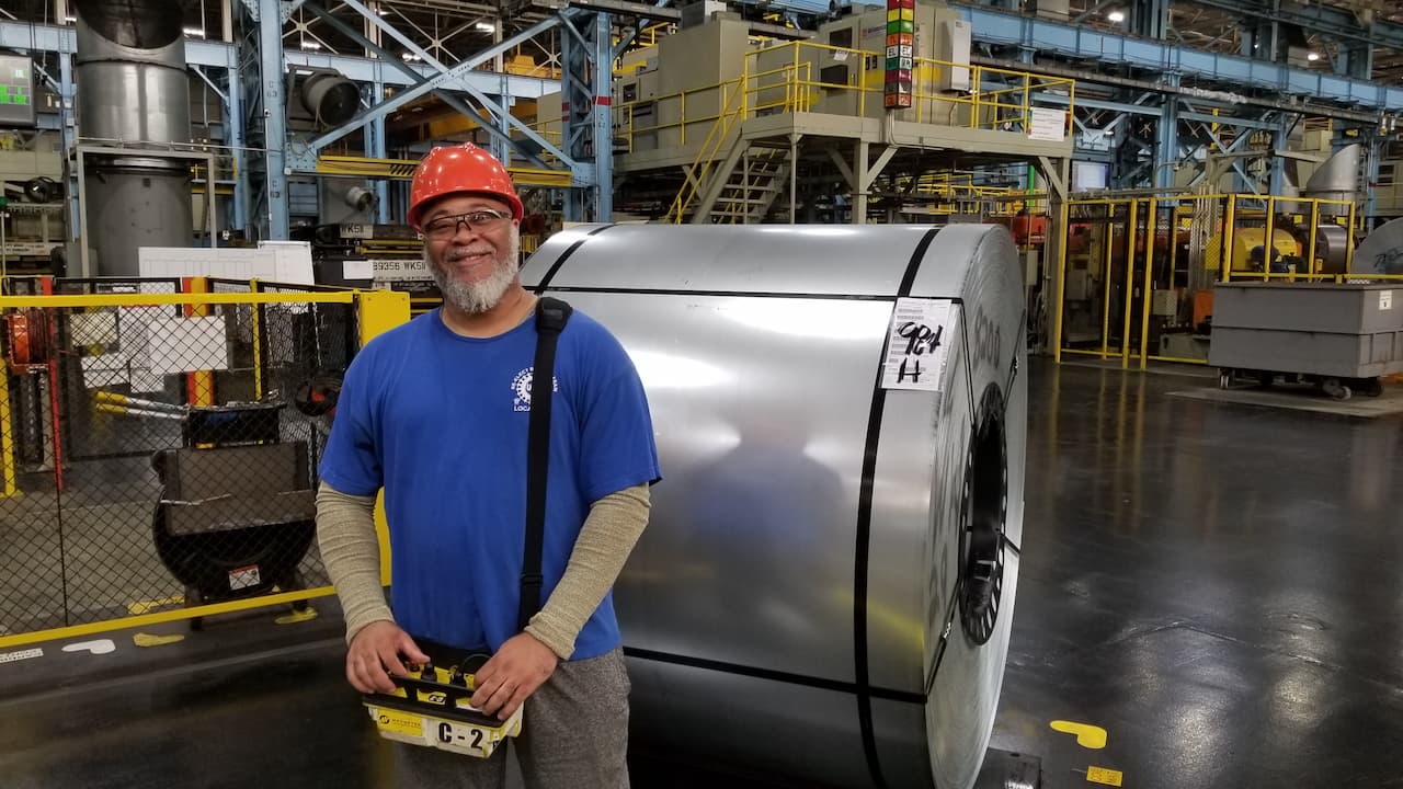 Morise Swift III prepares the controls to lift a large cylinder of metal within the plant 