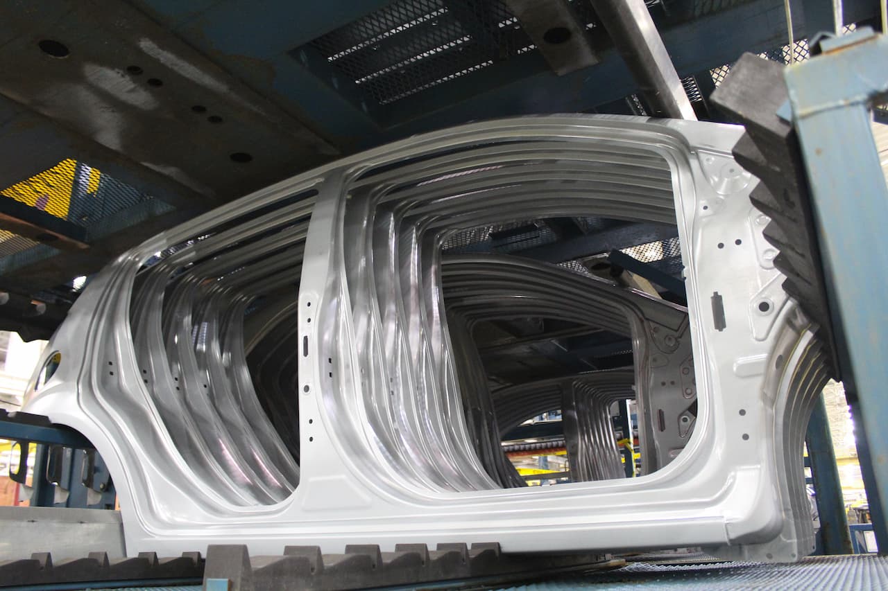Series of vehicle side metal assemblies ready for further assembly