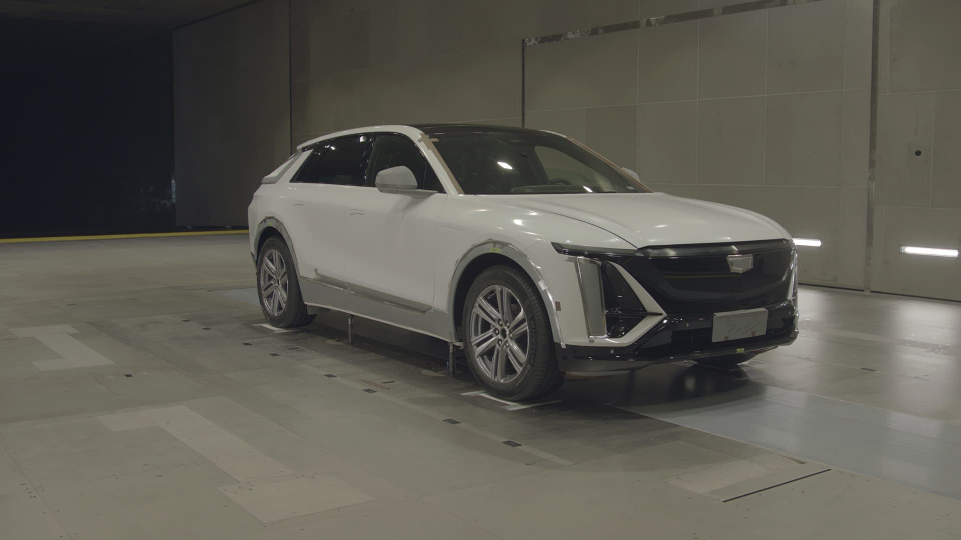 Artist rendering of black 2021 GMC Acadia Elevation parked in front of mixed use building