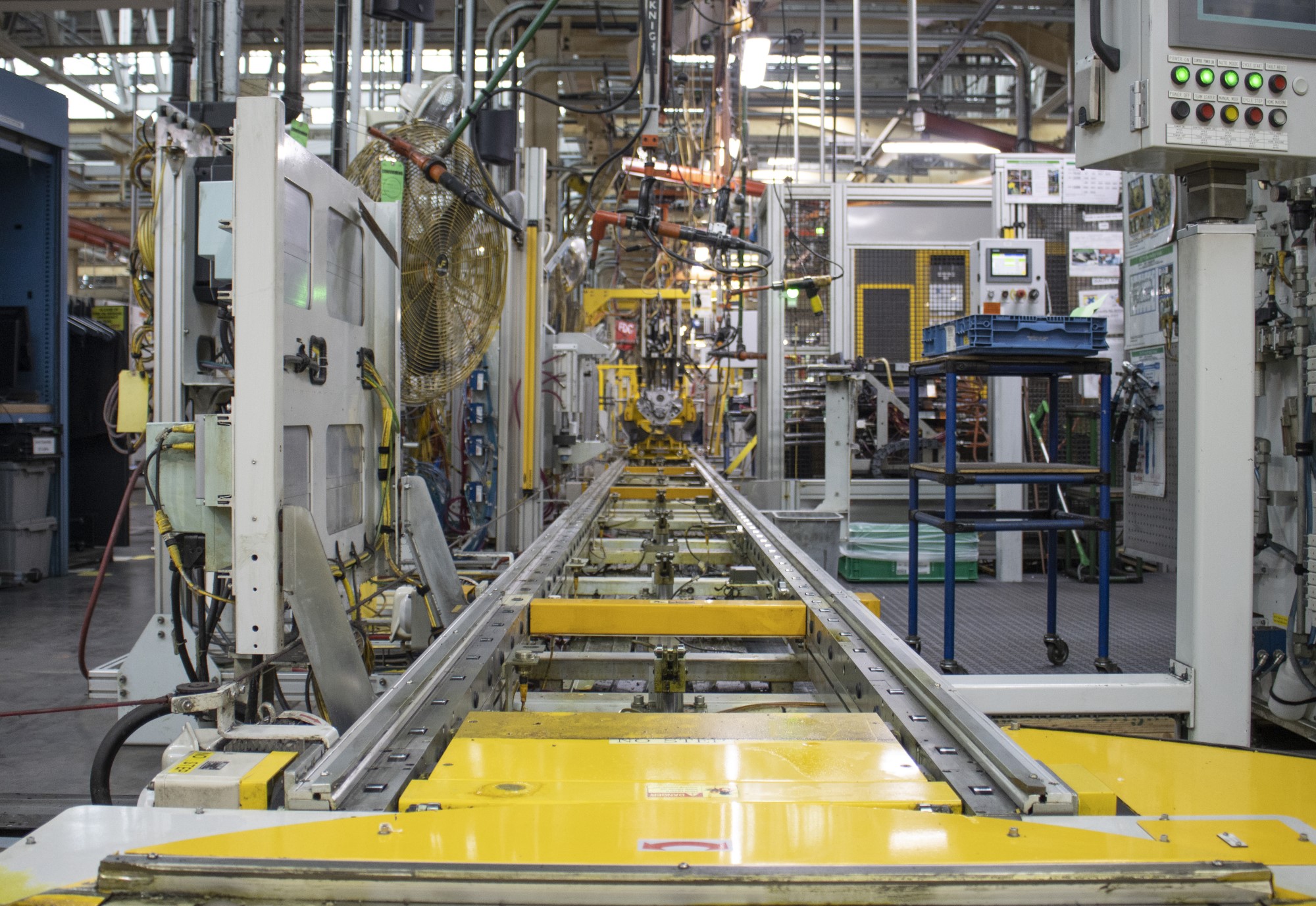 view down Tonawanda assembly line showing numerous tools, computers, and buttons to do engine production 