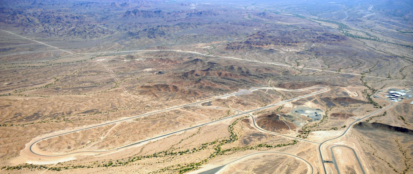 Aerial view of the Yuma Desert Proving Ground campus, including a 3.1 mile wide road, circular loops, dynamics pads and other testing