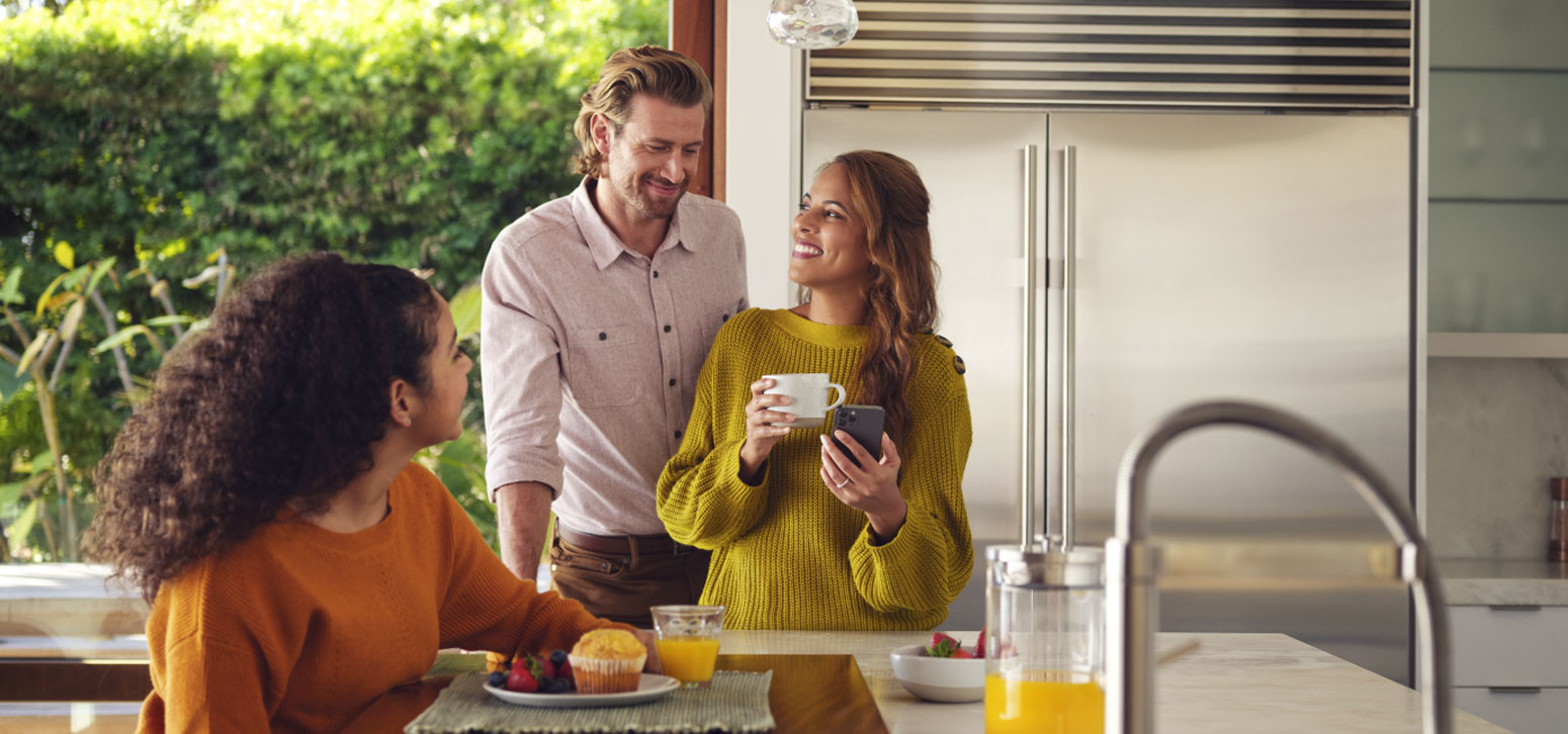 Family In Kitchen Eating Breakfast