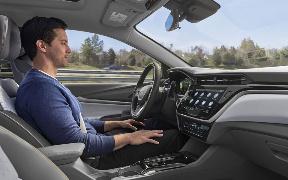 Man Utilizing the Super Cruise Hands-Free Driving Component in His GM Vehicle