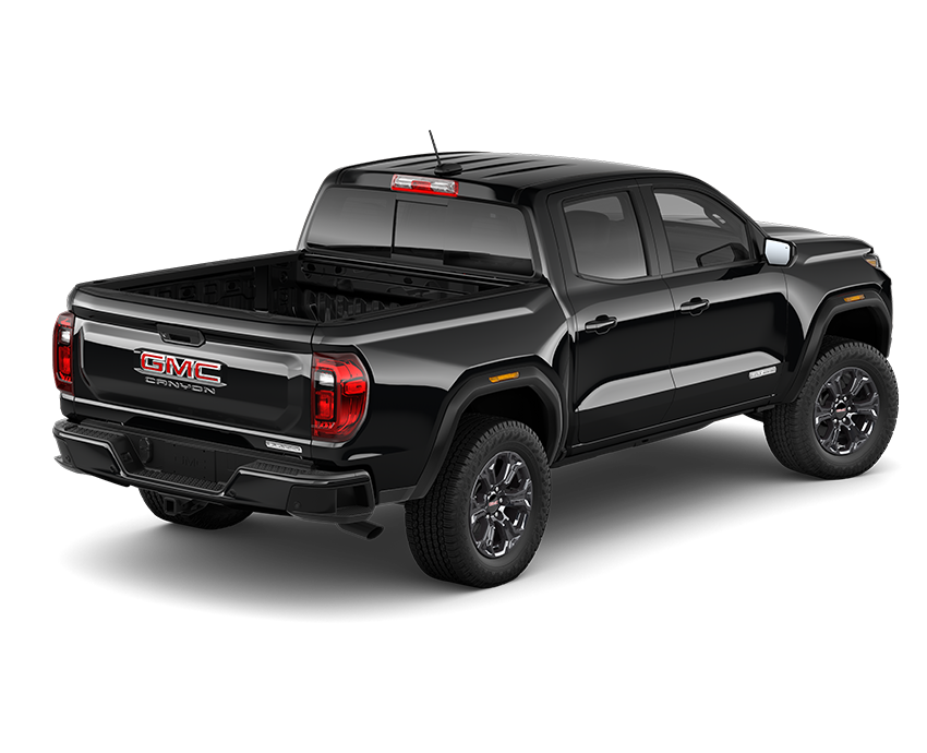 Three-quarter view of the Onyx Black 2025 GMC Canyon AT4 midsize pickup in showing open bed and rugged off-road stance.