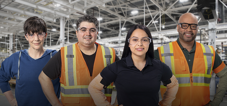 Six GM Manufacturing employees standing side by side