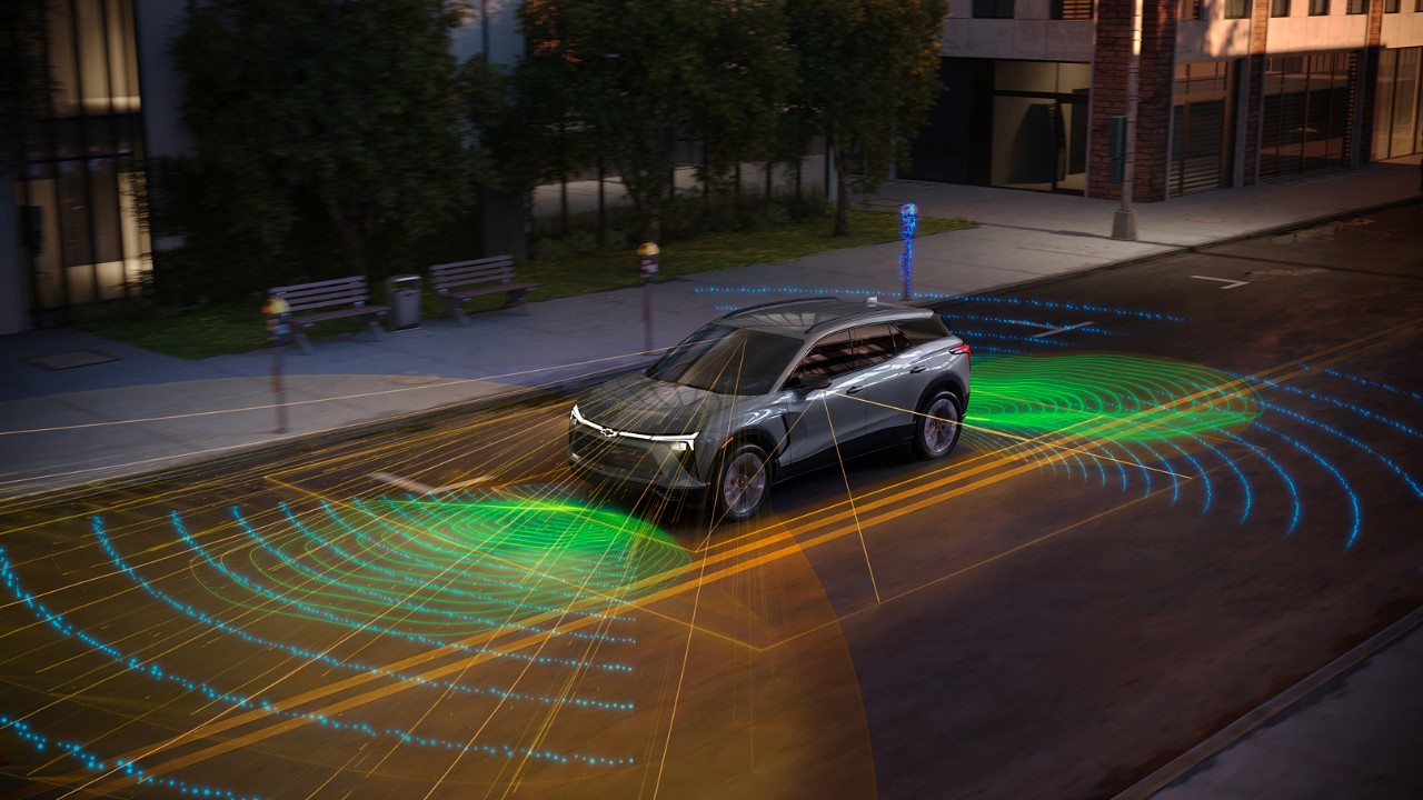 Technology Chevrolet EV SUV demonstrating autonomous driving technology with visualized LiDAR and sensor fields on urban street.