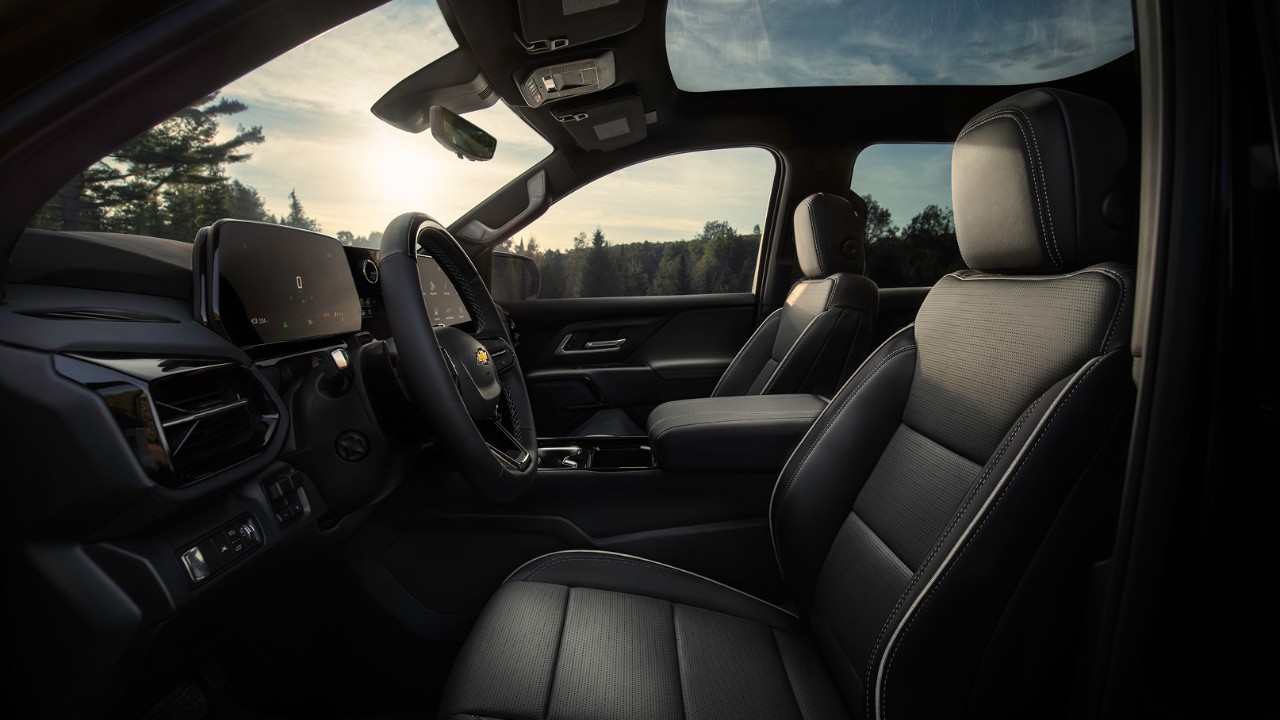 Craft Spacious front interior of a Chevrolet vehicle featuring premium black leather seats and digital displays.