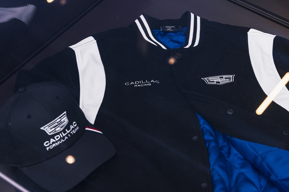 Cadillac Racing Branded Merchandise Featuring a Black Varsity Jacket and a Matching Cap