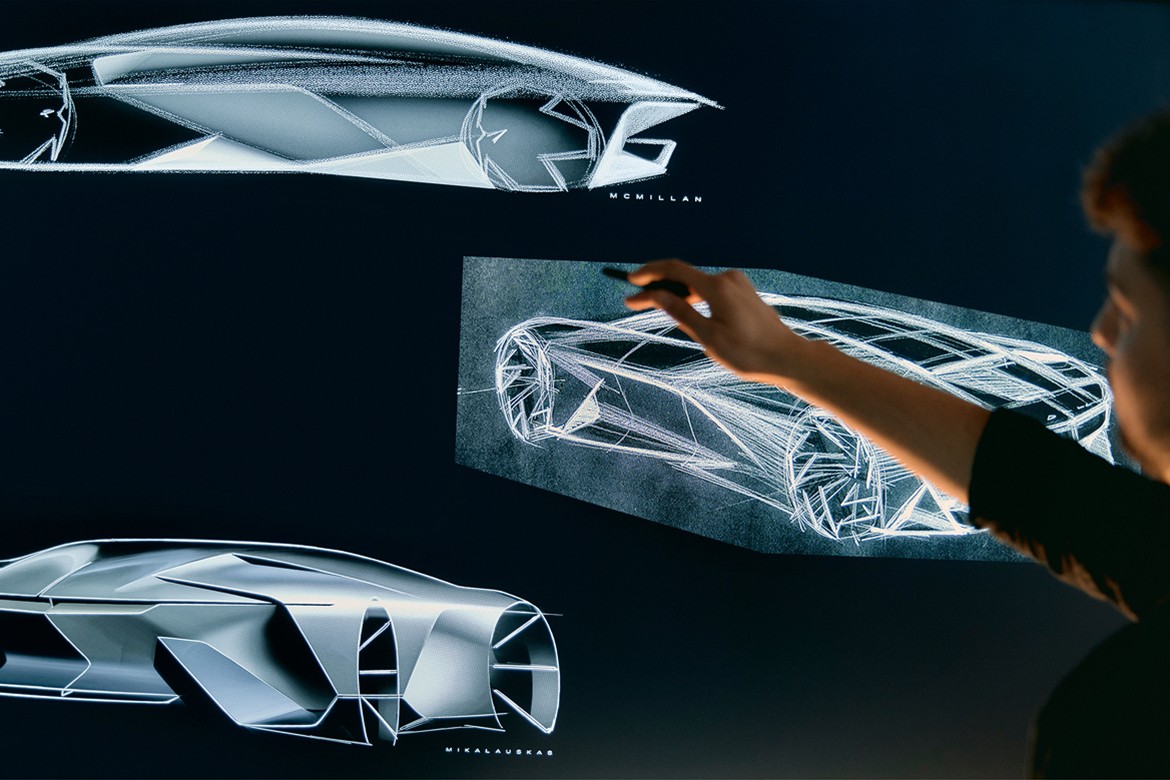 Careers Close-up of a Man Pointing on a Drawing Board Displaying GM’s Concept Vehicle Designs