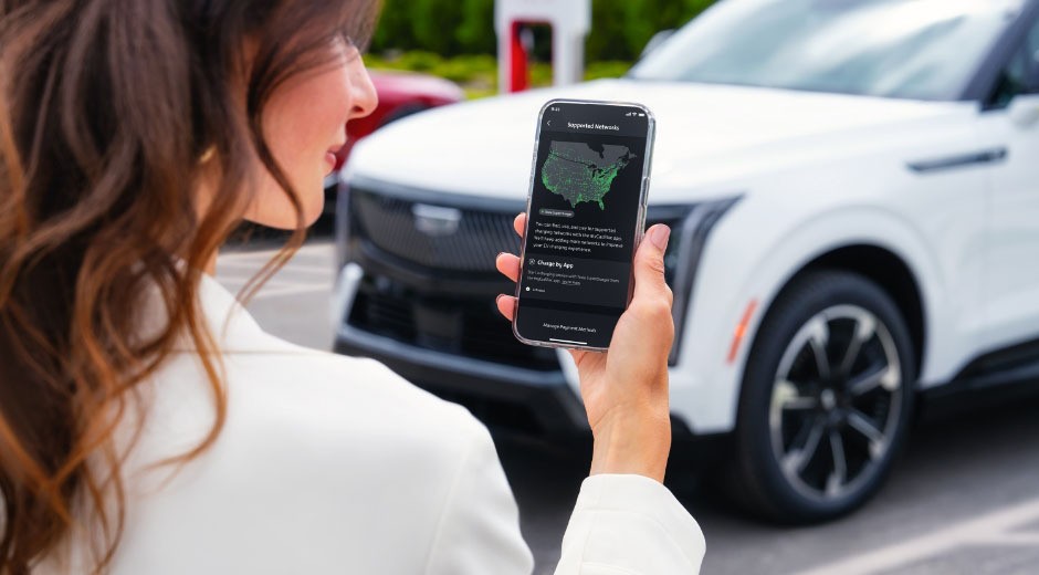 A Woman Smiling and Using the myCadillac Mobile App on iPhone